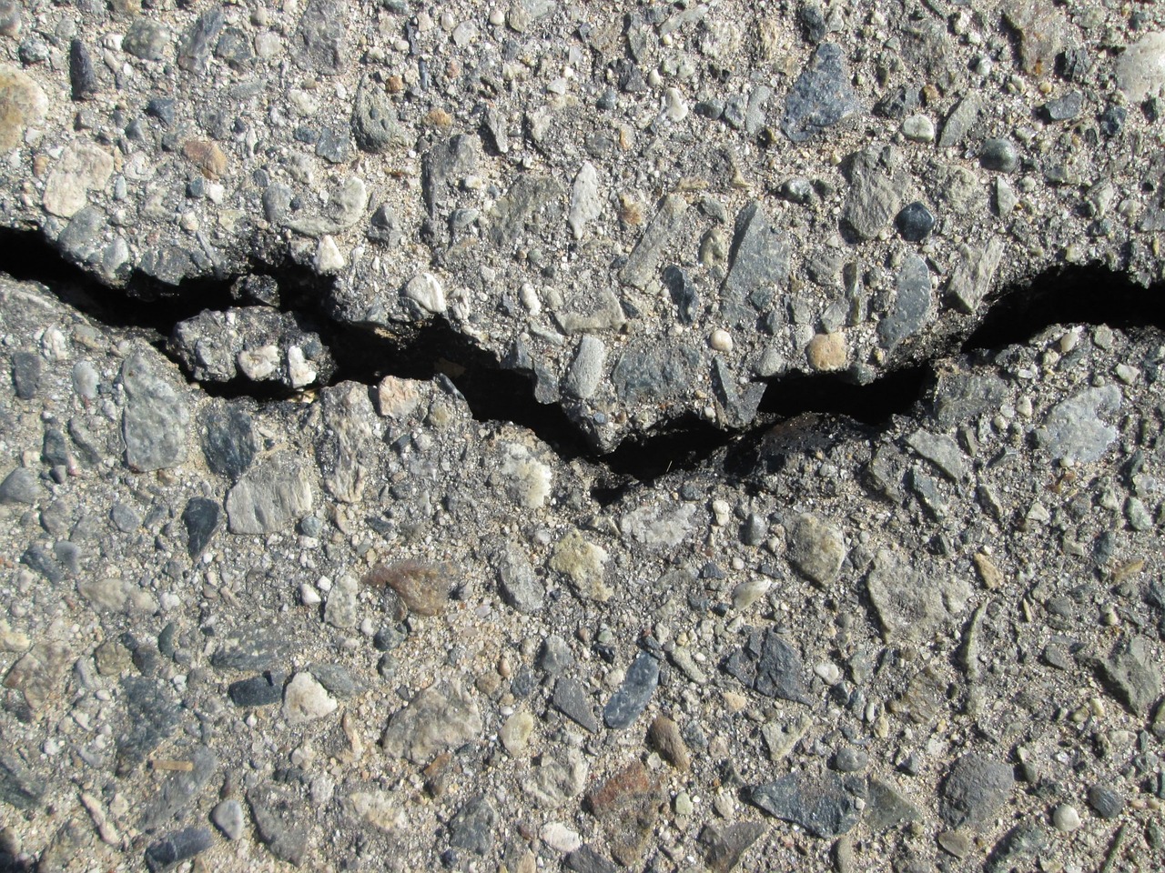 Sanierungsbedürftige Straßen in Westfalen erfordern dringend Maßnahmen, da Schlaglöcher und Risse den Verkehr stark beeinträchtigen.