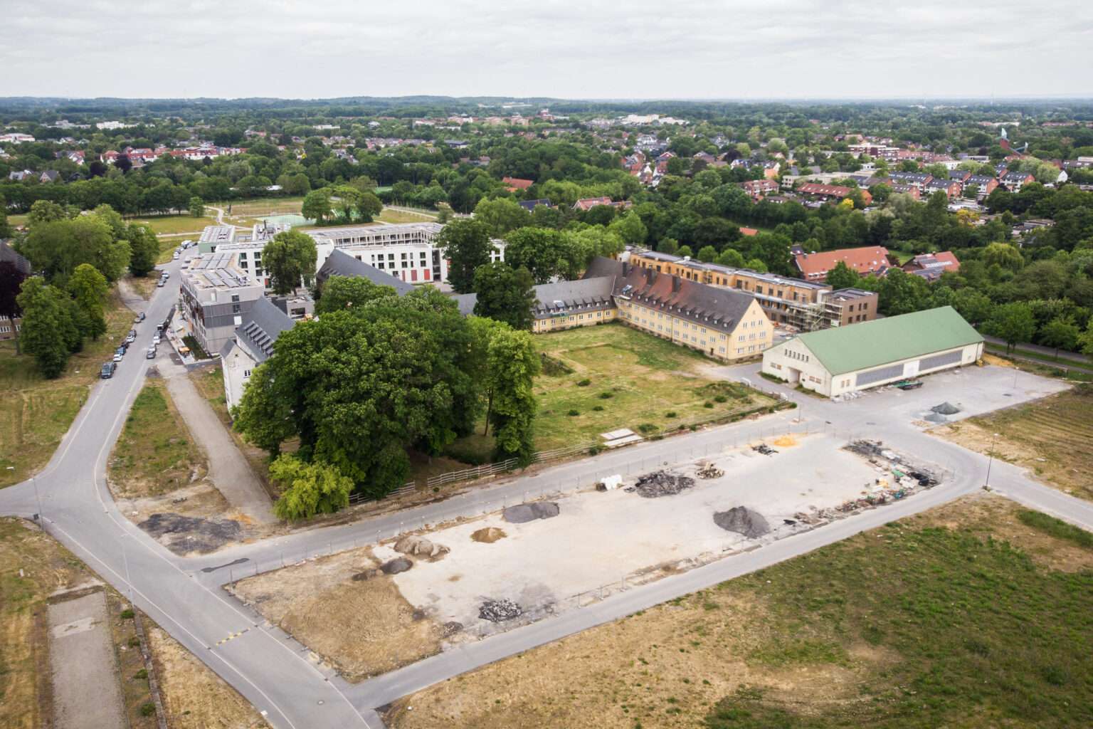 Das Oxford-Quartier Münster erhält ein neues Zentrum mit Kita, Wohnungen, weniger Versiegelung und neuen Nutzungsideen für Bestandsbauten.